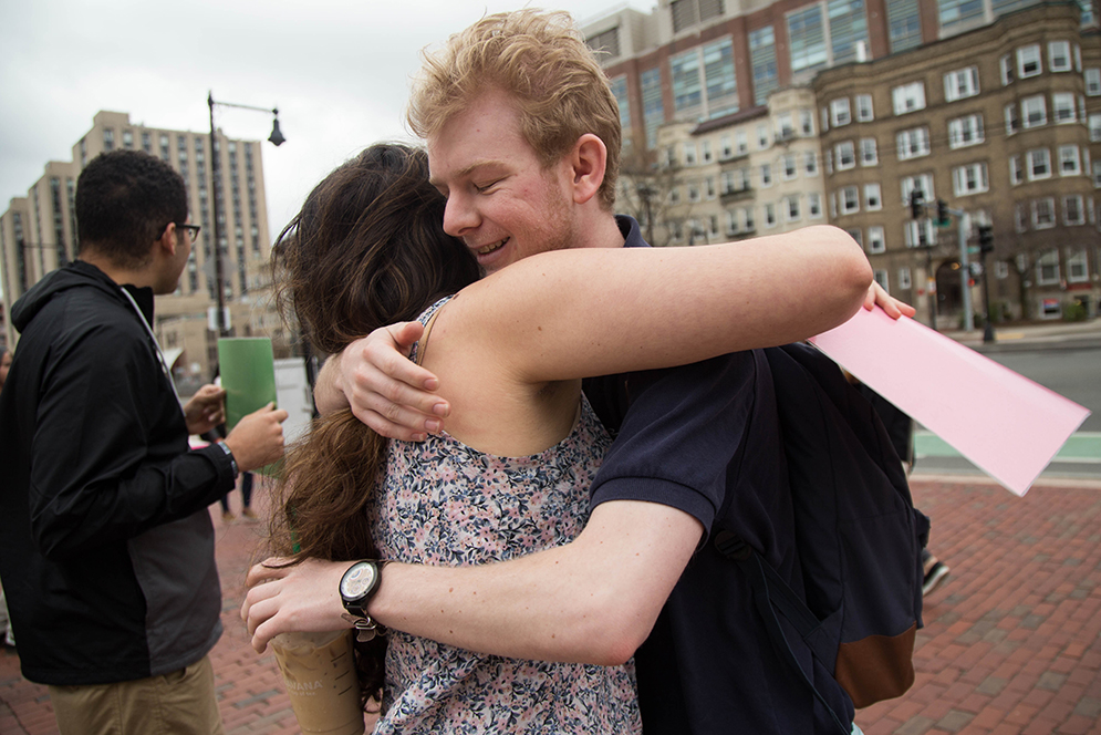 Owen Huzar (SHA'16) receives a hug from Melanie Kirsh, (CAS'16), who stands at the Marsh Chapel on Friday afternoons and offers free hugs to passersby. Kirsh is a member of BU HUGS (Humans United Giving Support)