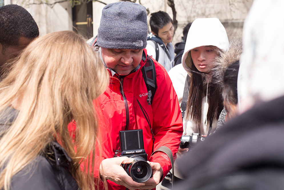 Pulitzer Prize winner and BU COM Adjunct Professor Greg Marinovich shares some camera tips and his knowledge on street photography with students from his advanced photojournalism class during a photography walkabout. Photo by Pankaj Khadka (COM'16)
