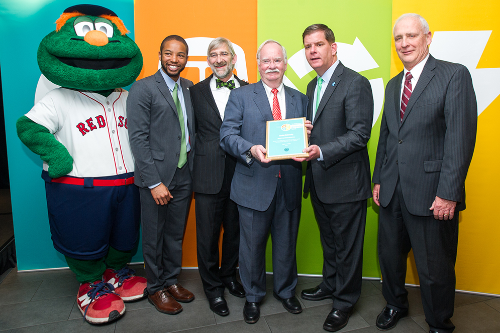 BU receives the the 2016 Greenovate Boston Awards in the Climate Preparedness and Resiliency category during a ceremony at Fenway Park April 22, 2016. From left is Wally, Austin Blackmon, Chief of Environment, Energy and Open Space, City of Boston, BU's Dennis Carlsberg, BU Pres Robert A Brown, Mayor Marty Walsh, and Tom Daley, Associate VP, FM&P. Photo by Cydney Scott