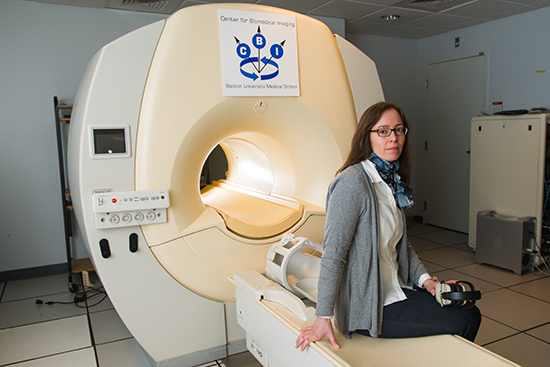 Boston University School of Medicine Researcher Karin Schon posed by an fMRI machine