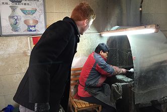 Oliver Sherman (COM’16, Questrom’16) learns how cloisonné vases are manufactured during a visit to Huairou Cloisonne in Beijing