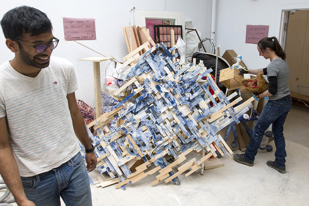 Bastyian Rodrigo (CFA'17), left, a CFA graduate student and Lydia Musco (CFA'07) a sculpture instructor clear out abandoned junior and senior pieces in the sculpture studio. Photo by Joe Difazio.