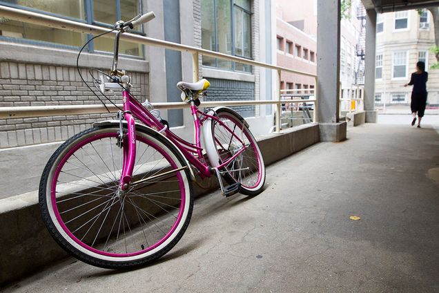 A pink bike sits behind Warren Towers begging to be ridden. 