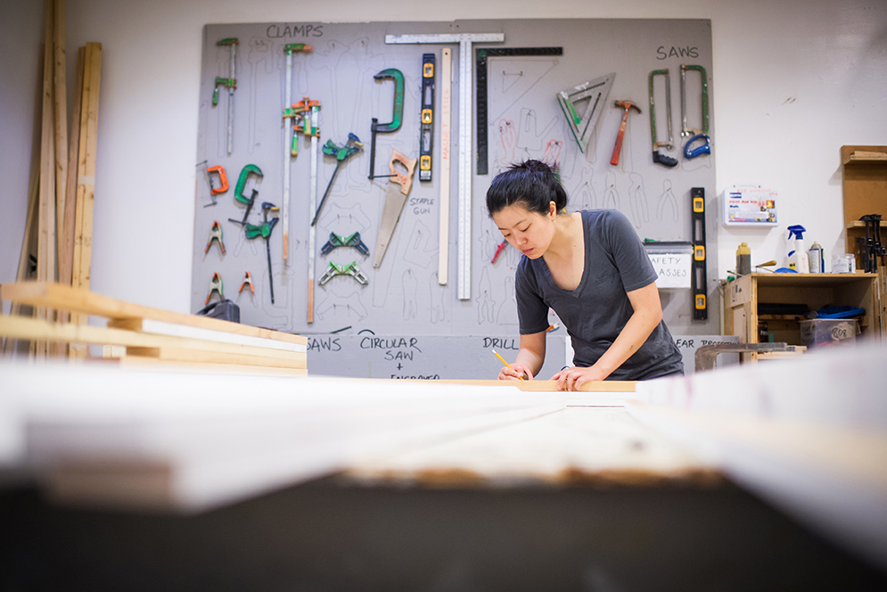 Grad student, Eung-Sun Lee (CFA'16) makes frames from old paintings in the School of Visual Arts' wood shop. Photo by Jackie Ricciardi