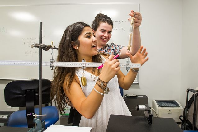 Nancy Mendez (CAS'18), front, and Maia Austin (McGill U,'19) work together on a lab called Torque and Moment of Inertia for their physics class June 16, 2016. Photo by Cydney Scott