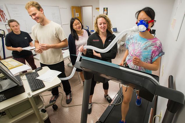 In an exercise physiology course at SAR, Katie Headley (SAR'18), from left, Luca Tramontozzi (SAR'18,'20), Shelomith Wong (National University of Singapore '18), and Katie Epstein (SAR'18)  learn how to run a stress test by using classmate Anneliese Tung (SAR'17) as their subject. Photo by Cydney Scott