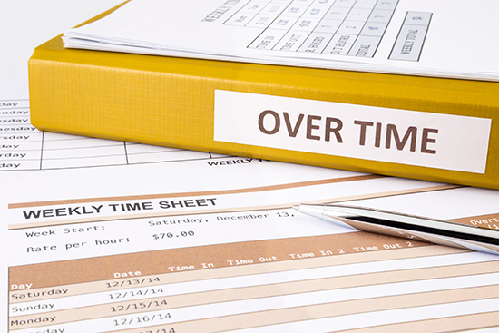 stock image showing time sheets and pay records calculating overtime pay