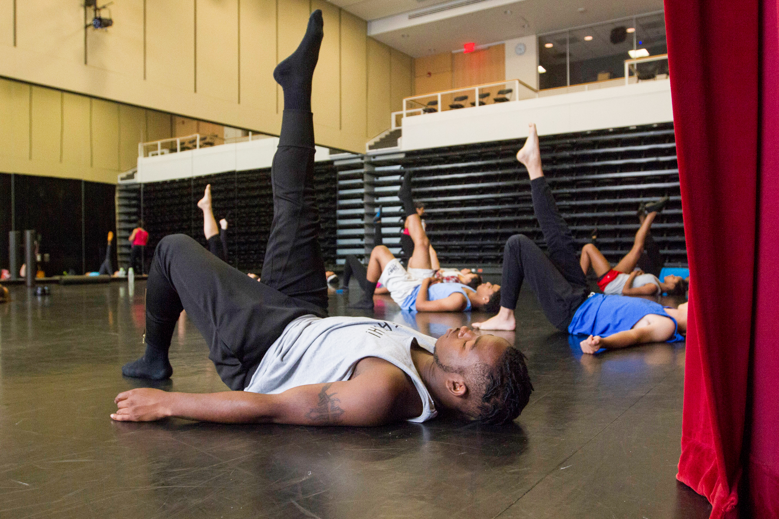 Brian Washburn of the REACH Summer Outreach Dance Program stretches for teaching dance
