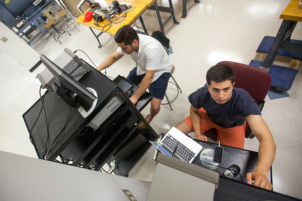 Students work on practicing a practical for a lab at the Boston University Photonics Center