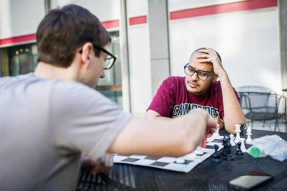 Boston University students play a game of chess outside George Sherman Union