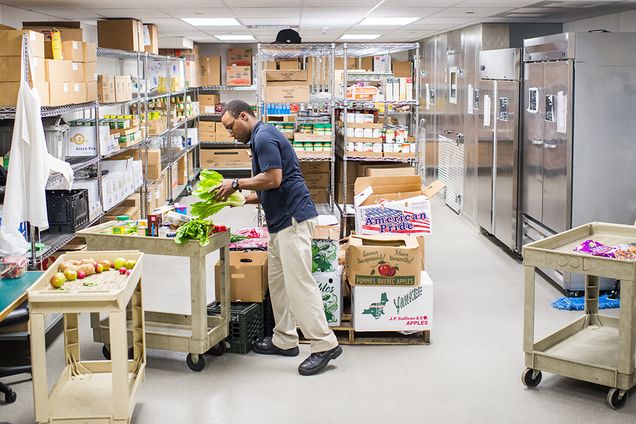 Jerome Edwards, Preventive Food Pantry Assistant, gathers food for patients