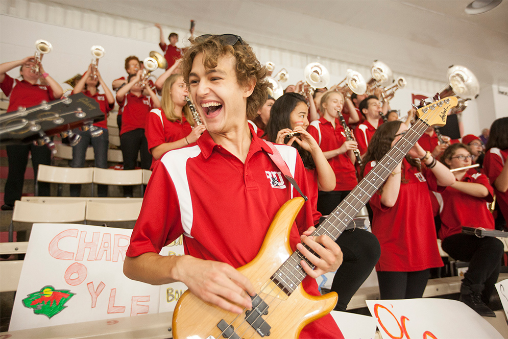 Bassist Simon Nichols performs with the Boston University band at the Comm Ave Charity Classic hockey game at Walter Brown Arena, 