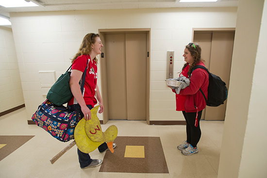 Pam Larson (SHA'15), left, and Julia case (CAS, CFA'14) outside of the elevators at Claftin Hall