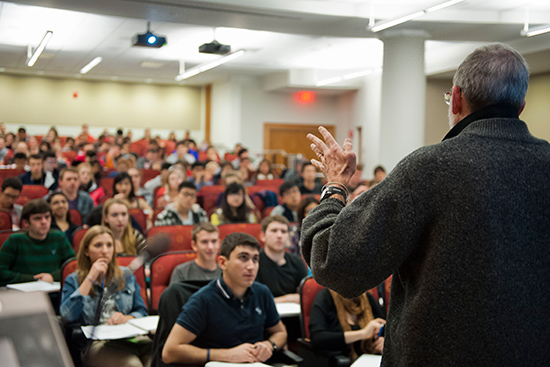 Professor teaching room full of students