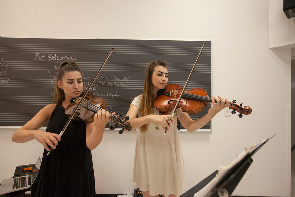 Brianna Fischler (CFA’15), left, and Elizabeth Moore (CFA’14 Masters) play viola in a practice room in CFA