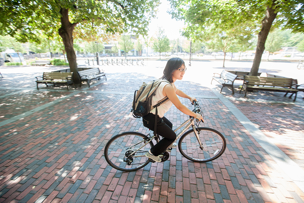 Student riding her bike from the George Sherman Union