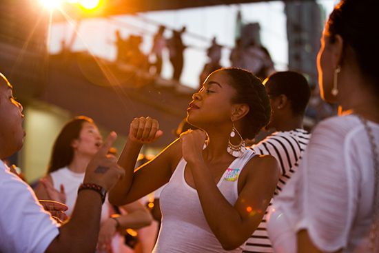 Woman dancing in a crowd at the ICA's "beach party" event