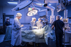 Surgeons and nurses operate in a hospital operating room