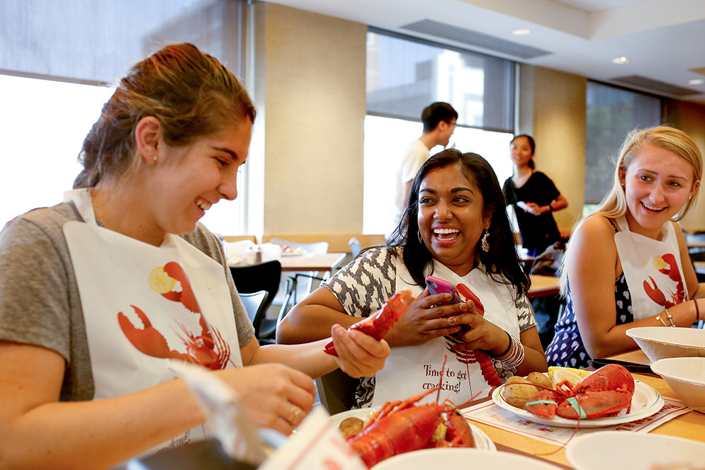 Ramya Vemulapalli (SAR’20), Breann Tobias (CAS’20), Emily Jarzabek (SAR’20) cracking lobster during Lobster Night  