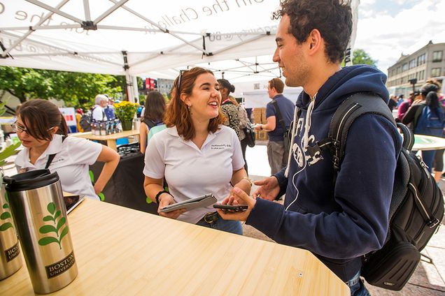 Julia Shaw (CAS'18) helps Fernando Payro (CAS PhD '19)  at the Sustainability Festival