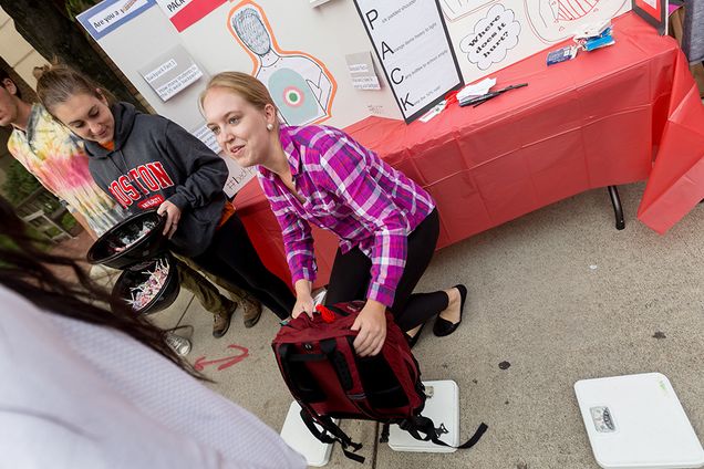 Grace Kelso (SAR '19) weighs a backpack 