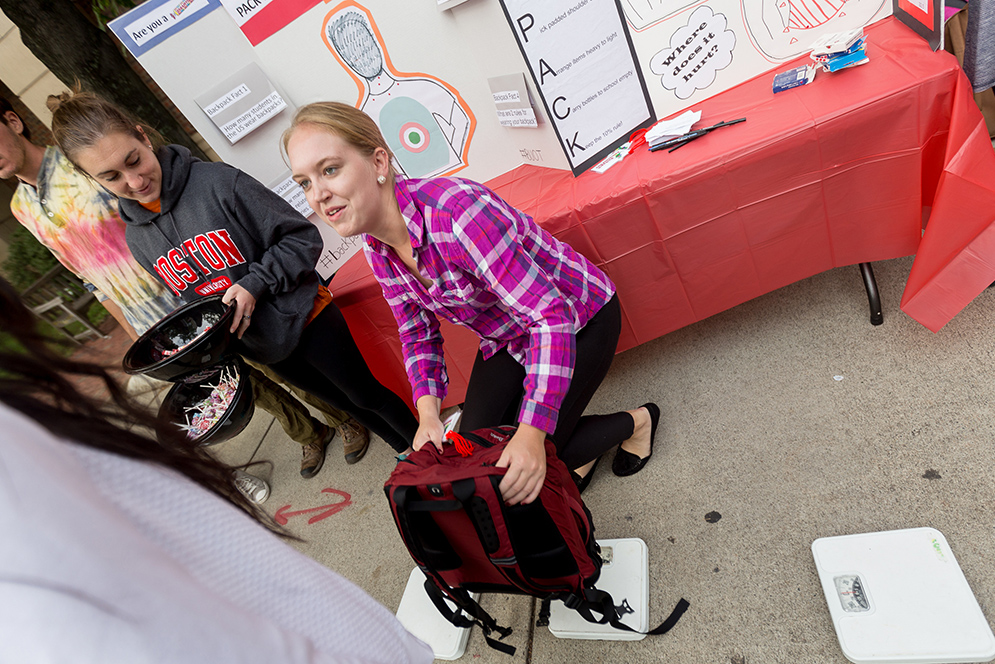 Grace Kelso (SAR '19) weighs a backpack 