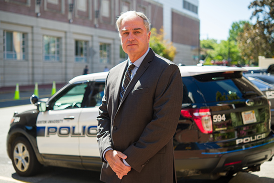 Dept. Cheif Tom Robbins standing in front of police car