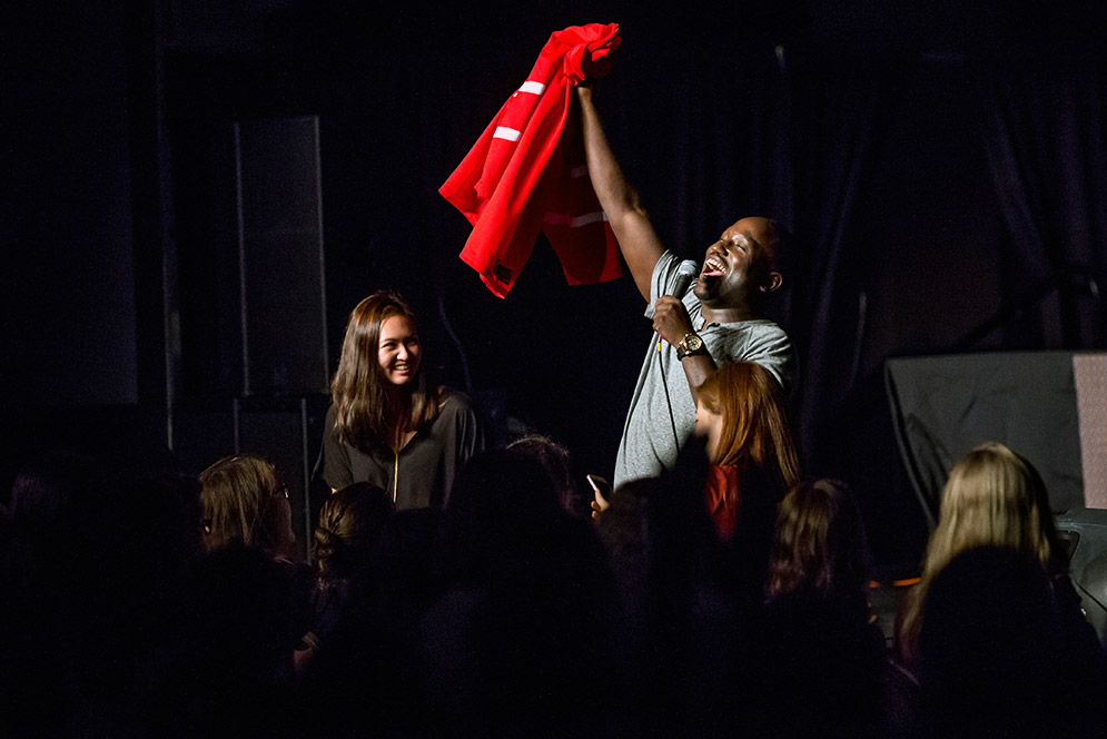 Hannibal Buress holding up red sweater