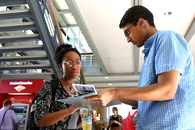 Rahul Agarwal (SAR’17) explains to Gloria Ihenetu (CGS’17, CAS’19) the voter registration form 