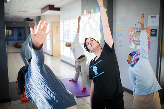 Susan Lovett (SSW’98) teaches yoga class