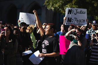 Students hold signs and chant during a Black Lives Matter protest on Marsh Chapel Plaza at Boston University