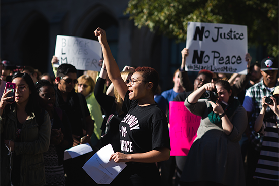 Students hold signs and chant during a Black Lives Matter protest on Marsh Chapel Plaza at Boston University