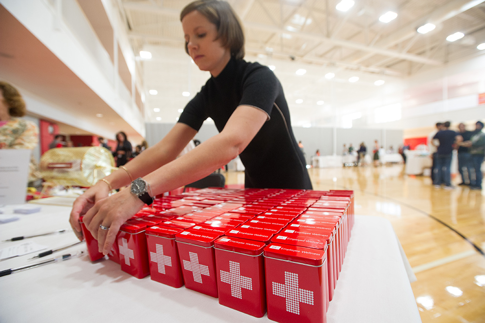 Eugenia Rose, senior benefits analyst, restocks mini first aid kits