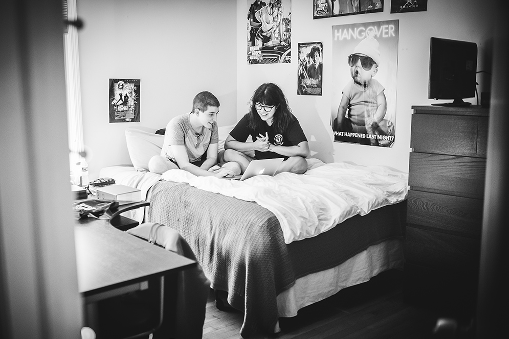 Skylar and his friend, Glo sitting on a bed