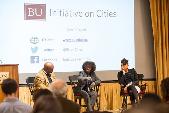 Boston officials Atyia Martin (center) and Karilyn Crockett sitting down on chairs