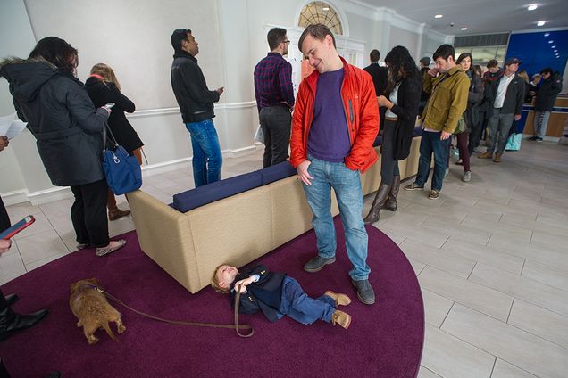 Four-year-old Felix Sergeev lays on the ground while his dad Rinat Sergeev looks over him
