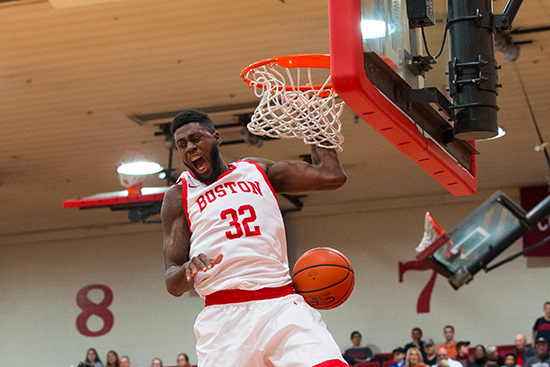 Justin Alston (CGS’14, SHA’16, MET’17) dunks a basketball during a game