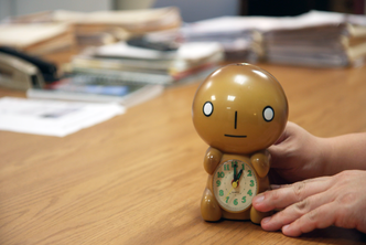 hand setting clock back one hour