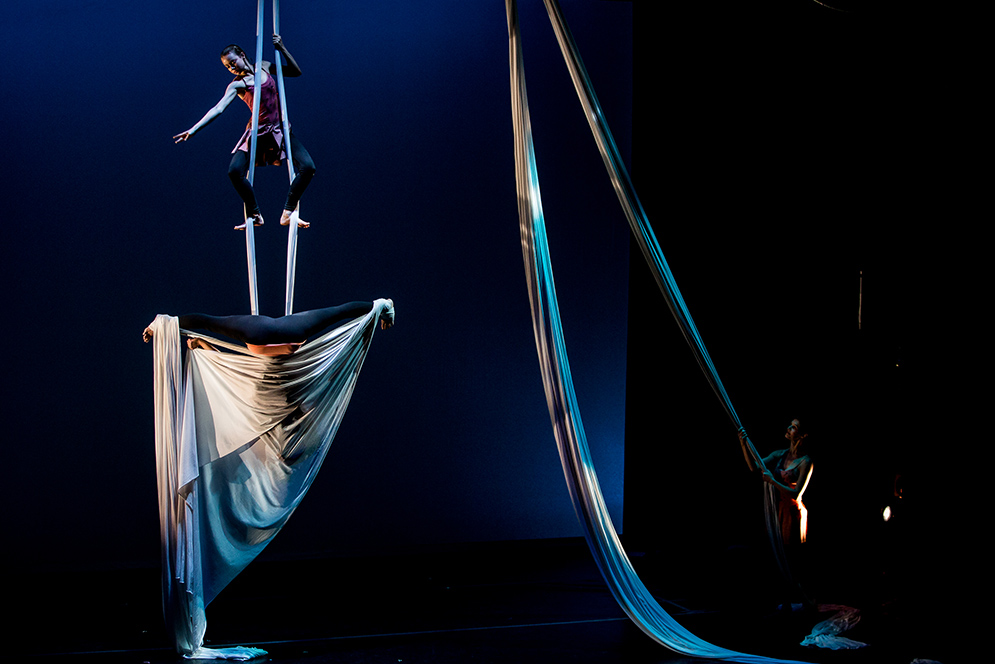 Dancers performing aerial dance piece on stage