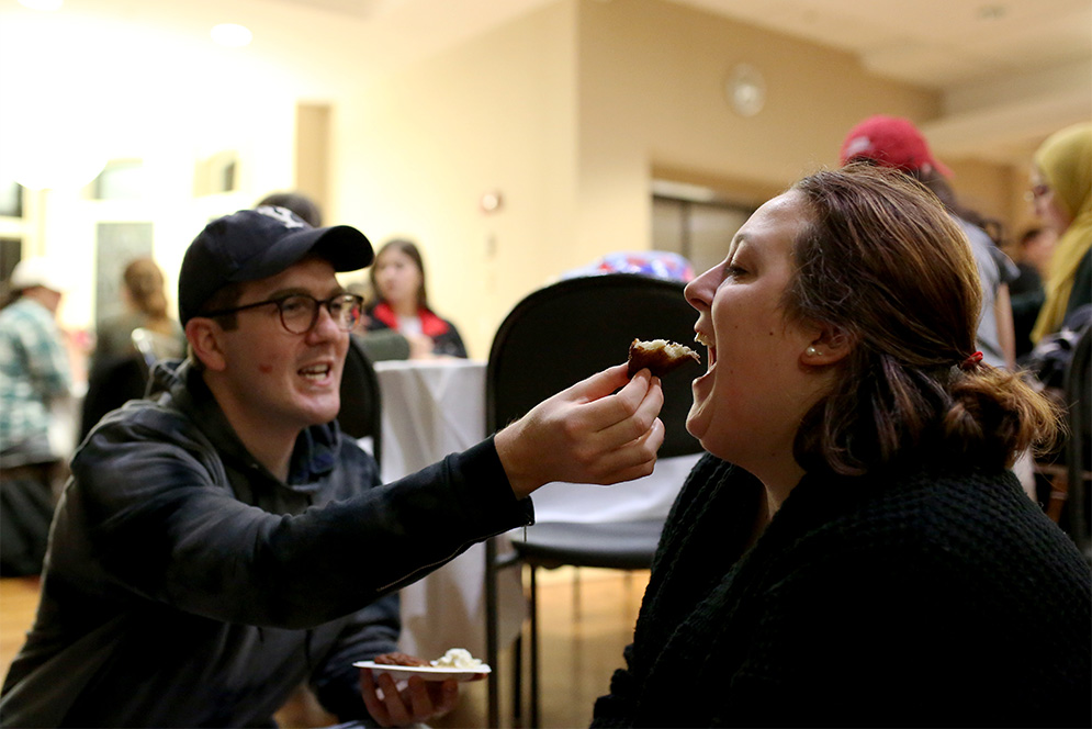 Boston University students feed latkes to each other during the Latkepalooza event at Hillel House