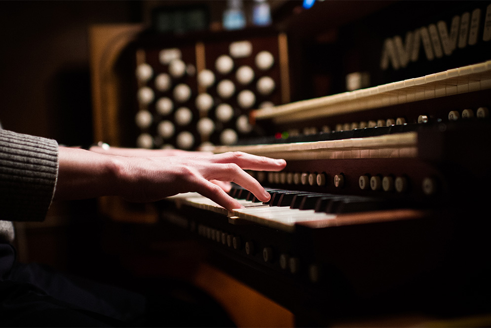 Marsh Chapel organist Justin Thomas Blackwell's hands playing the organ
