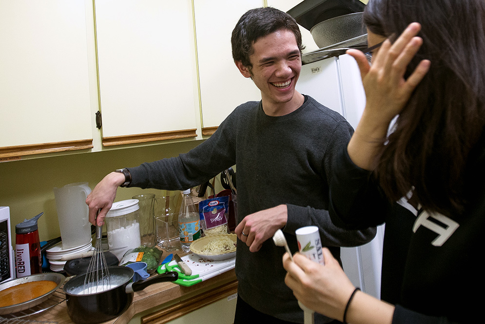 Boston University students Dominique Chueng and Ian Quillen prepare quiche during the Marsh Chapel Global Dinner Club event