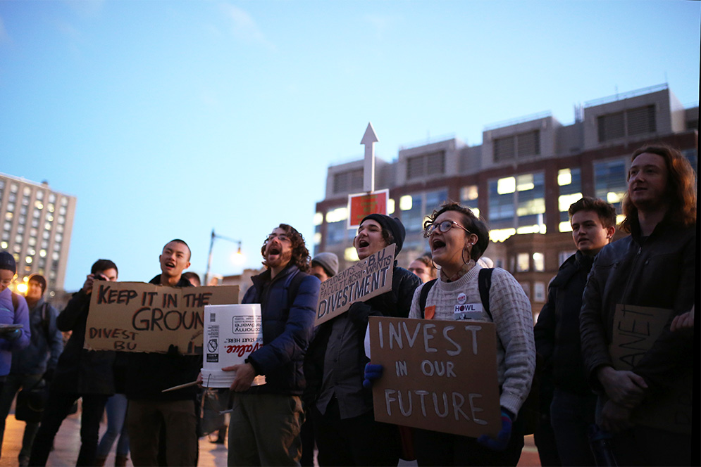 Students from the Divest BU student group rally on Marsh Plaza to urgre Boston University President Robert Brown and the BU Board of Trustees to divest the university's endowment from fossil fuel holdings