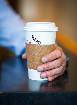 Remi Trudel holding a coffee cup