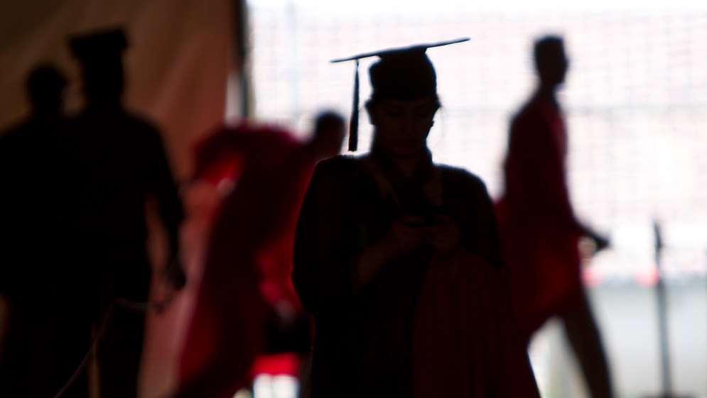 Silhouette of graduating students in cap and gown