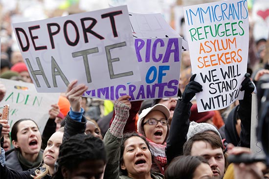 Demonstrators display pro-immigrant signs at the Boston Protest Against Muslim Ban and Anti-Immigration Orders, January 29, 2017 in Copley Square, Boston