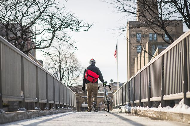 Cyclist walking bike