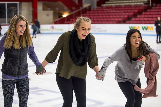 BU students holding hands while skating
