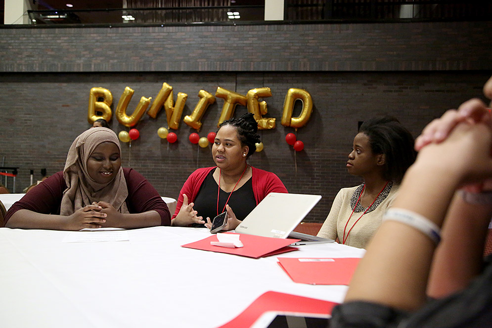 Fardowsa Abdulle, Joi Henry, and Kelechi Alfred-Igbokwe having conversation at table