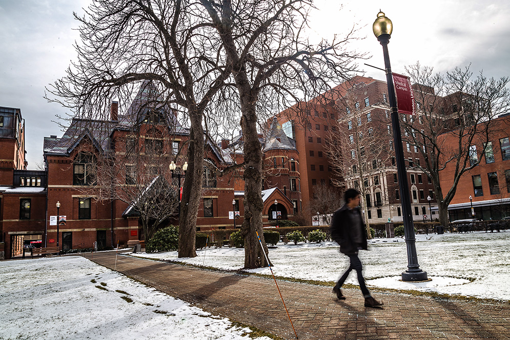 student walking across BU Medical Campus